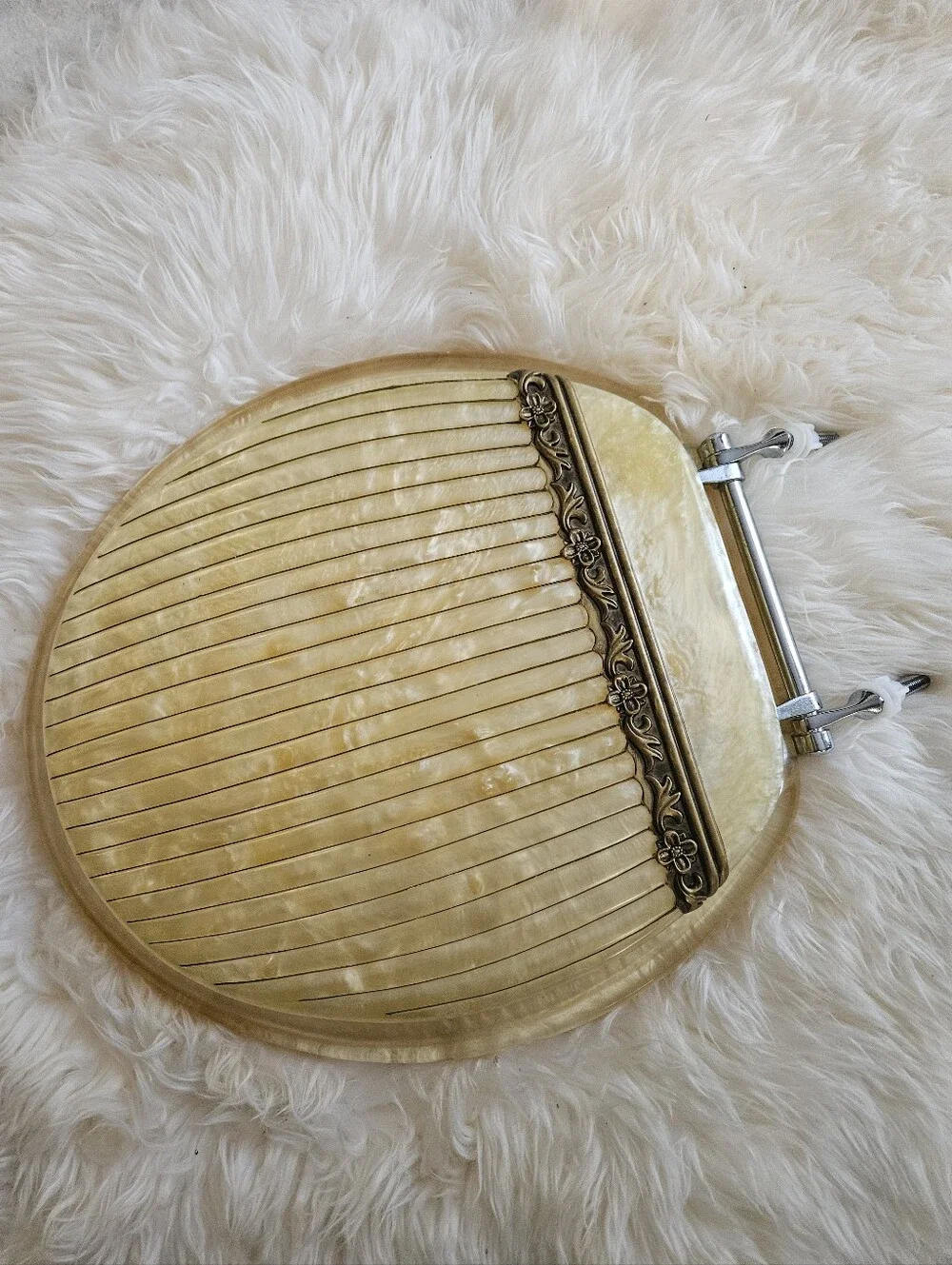 Vintage-Inspired Cream Toilet Seat Round with Decorative Hinge Accent Elegant.